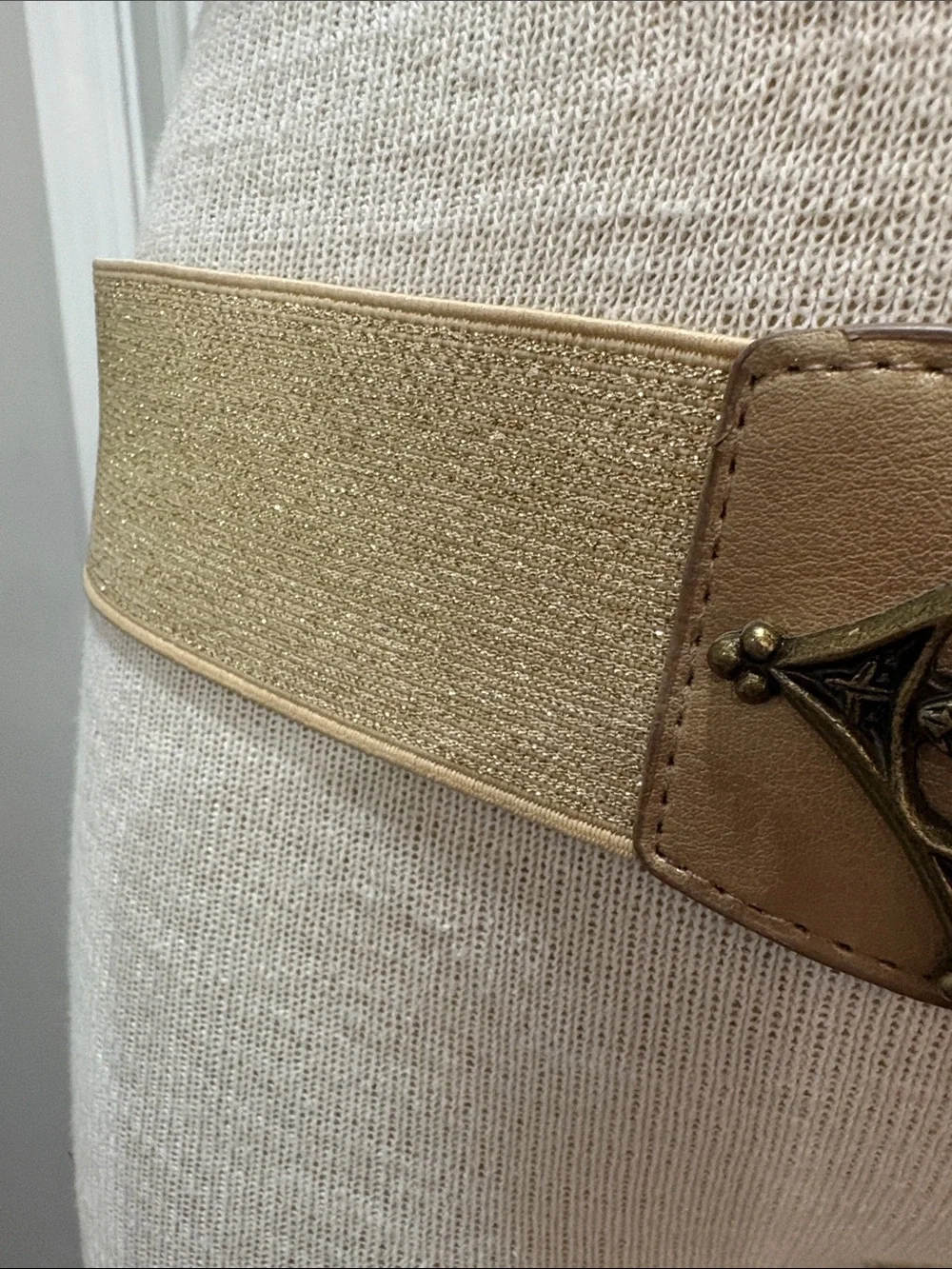 Metallic gold stretchy belt with ornate brass look buckle